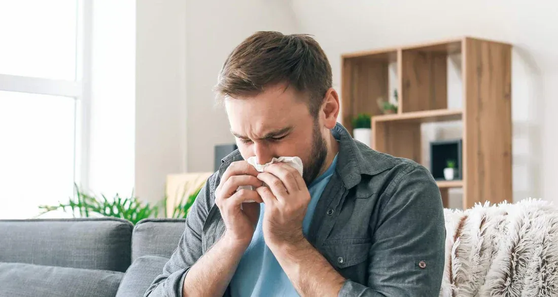 A man sitting on the cough dealing with congestion