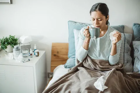 A_woman_sick_in_bed_with_a_fever_480x480.webp