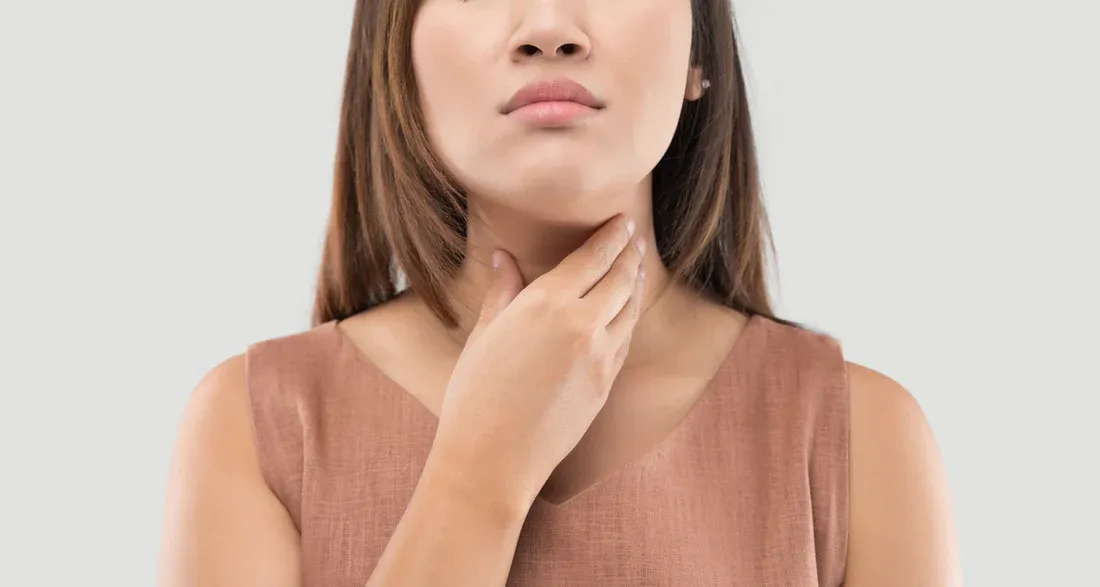 A Women suffering from Throat pain