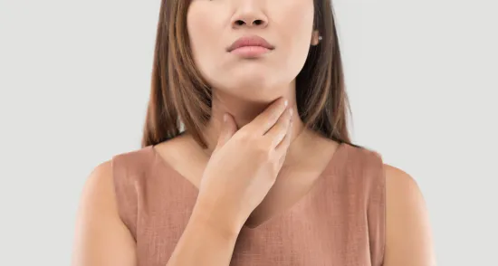 A Women suffering from Throat pain